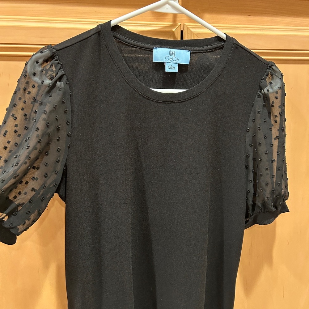 Black top with polka dot sheer sleeves
